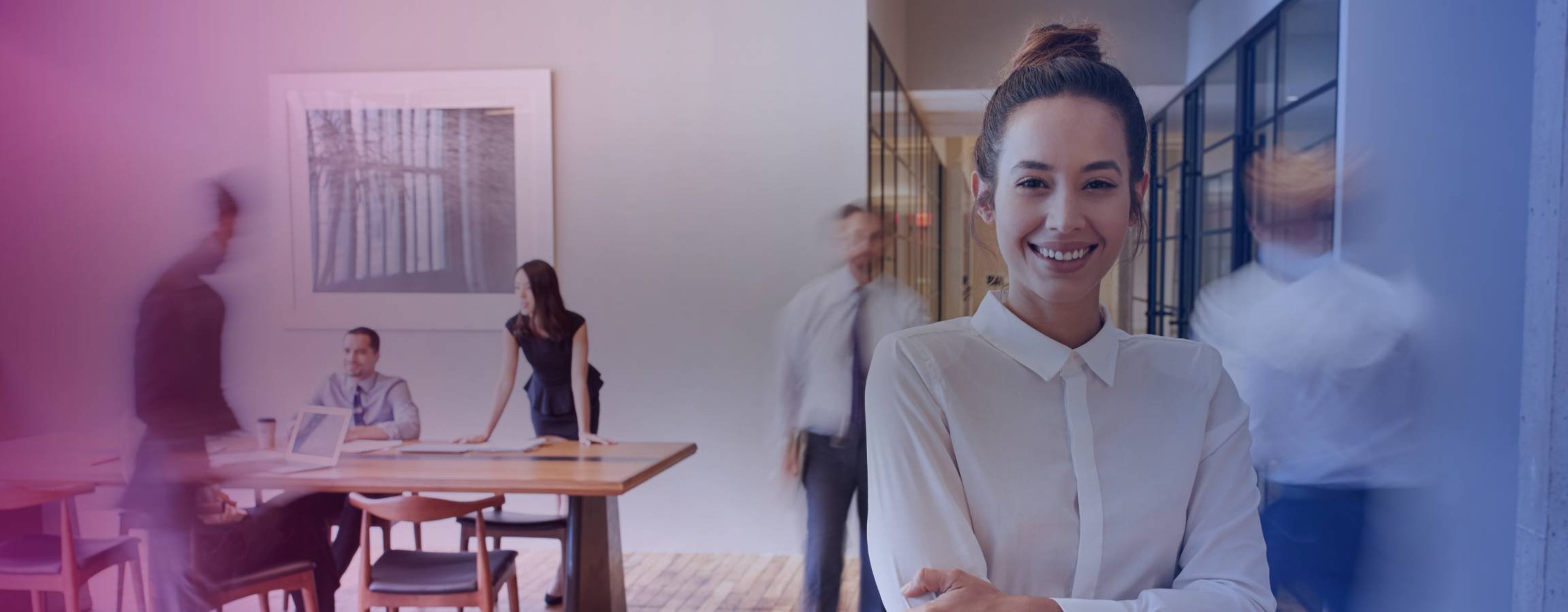 woman smiling at the camera in a busy office